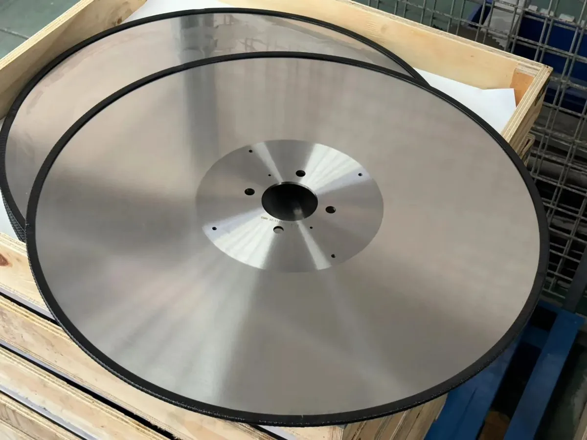 Stack of finished tissue log saw blades in a wooden packing crate at Sureay