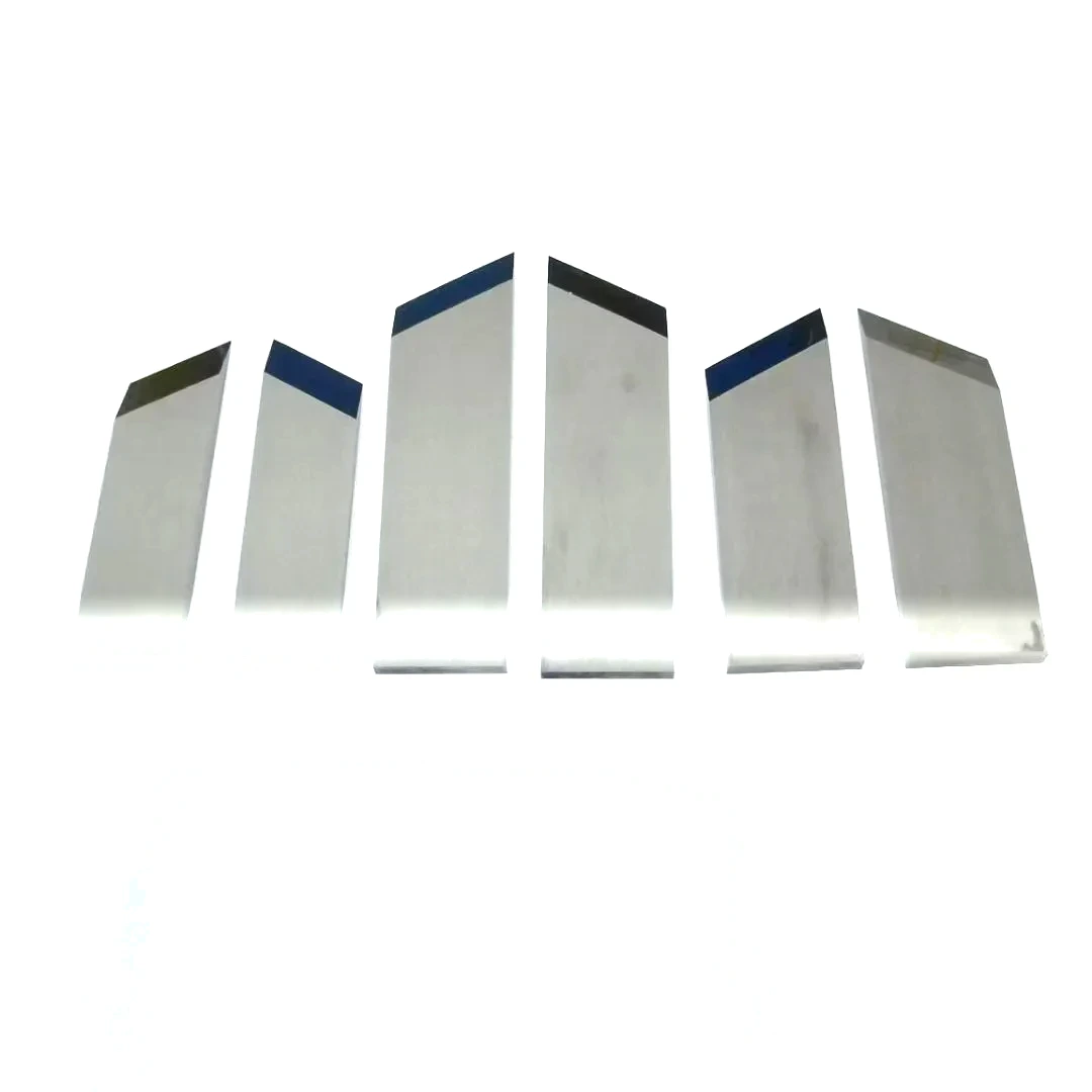 Six carbide box slotting knives fanned out to show the stock length and width range