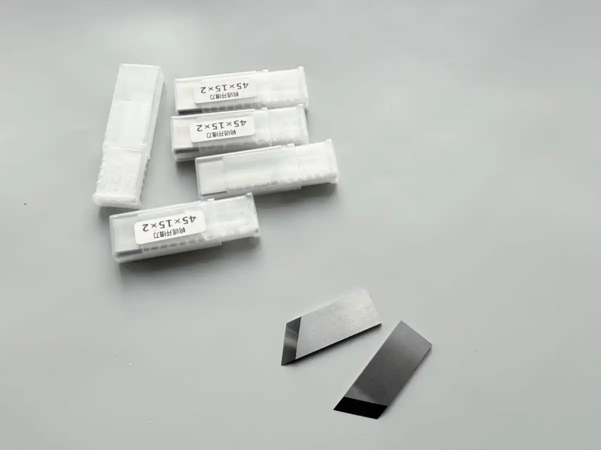 Box slotting knives in labelled protective cases alongside two loose knives