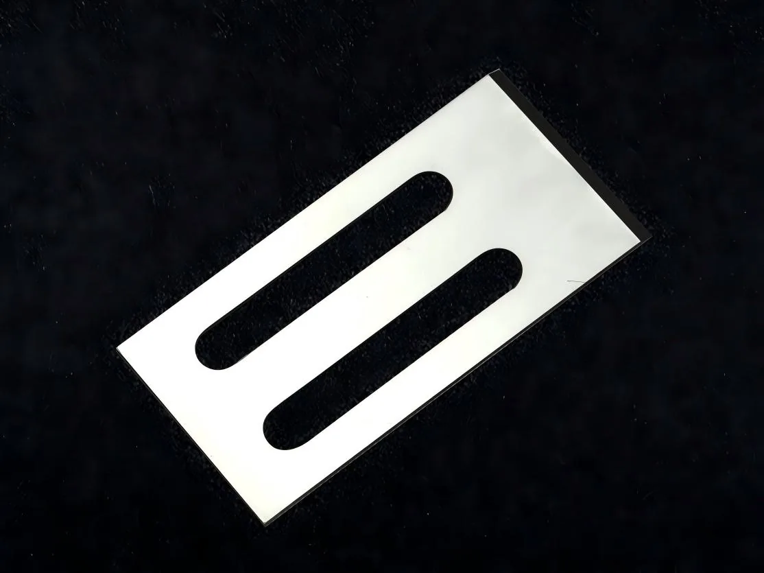 Close-up of a single die face cutting knife showing the ground cutting edge and twin mounting slots