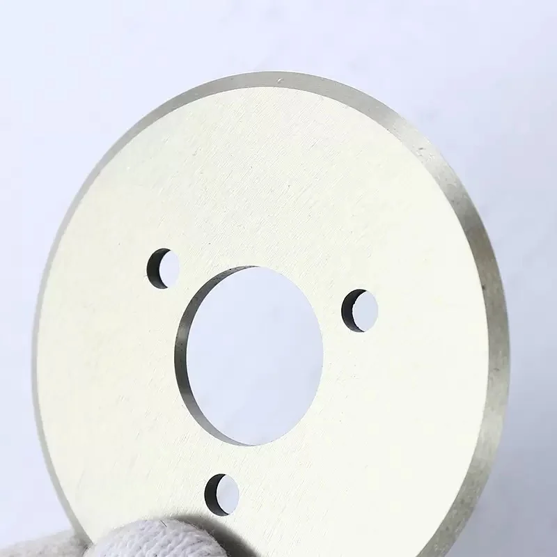 Carbide slitter knife detail showing centre bore, mounting holes and ground cutting edge